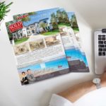 stack-of-color-just-sold-real-estate-flyers-or-postcard-on-desk-next-to-laptop